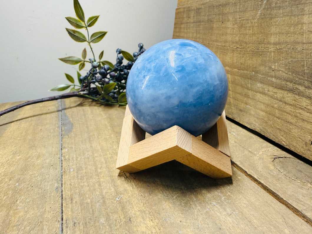 Natural Blue Calcite sphere on wooden stand