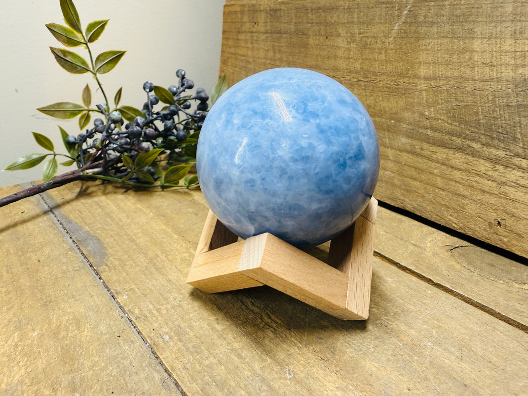 Natural Blue Calcite sphere on wooden stand