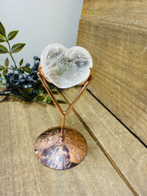 Load image into Gallery viewer, Polished Clear Quartz love heart on rose colored metal stand with zodiac sign