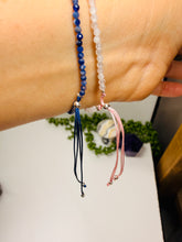 Load image into Gallery viewer, Two beaded bracelets on a wrist with a decorative stone in the background