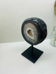 Large Natural Agate Geode with Quartz crystals inside on black stand