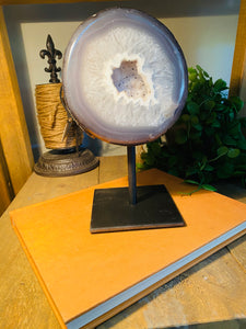 Large Natural Agate Geode with Quartz crystals inside on black stand