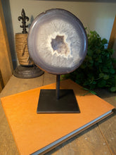 Load image into Gallery viewer, Large Natural Agate Geode with Quartz crystals inside on black stand