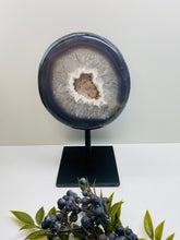 Load image into Gallery viewer, Large Natural Agate Geode with Quartz crystals inside on black stand