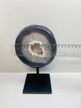 Load image into Gallery viewer, Large Natural Agate Geode with Quartz crystals inside on black stand