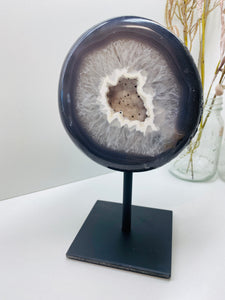 Large Natural Agate Geode with Quartz crystals inside on black stand