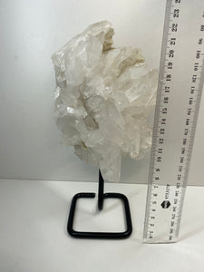 Large clear quartz on black stand