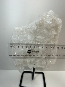Large clear quartz on black stand