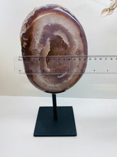 Load image into Gallery viewer, Large Natural Agate Geode with Quartz crystals inside on black stand