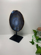 Load image into Gallery viewer, Natural polished Agate slice on black stand with gold electroplating around the edges 09