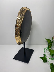 Natural polished Agate slice on black stand with gold electroplating around the edges 09