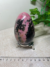 Load image into Gallery viewer, Rhodonite egg display piece - office decor or unique home display piece