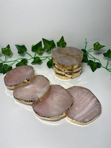 Rose Quartz slice drink coasters with gold electroplating around the edges